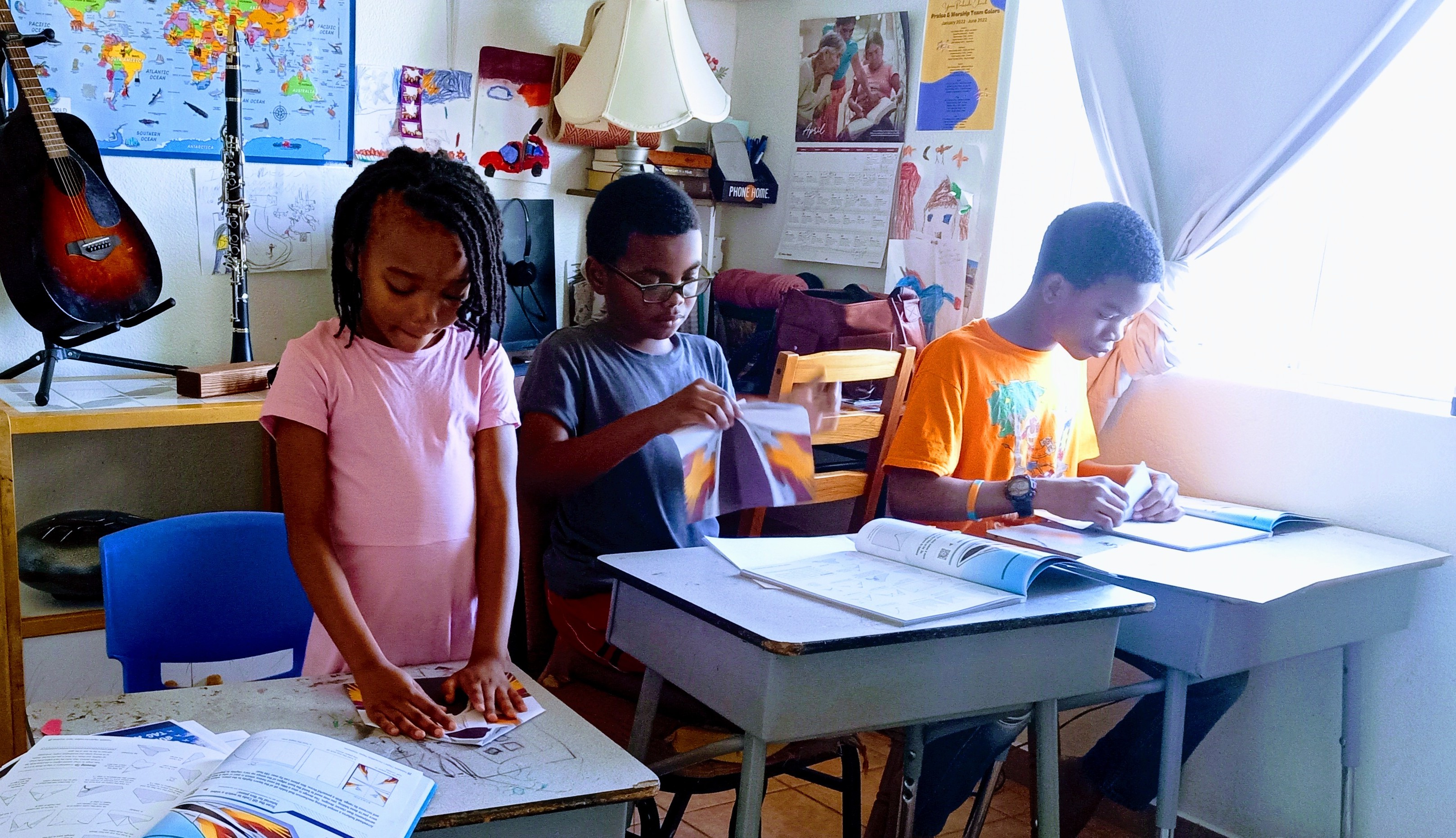 Students work to fold paper airplanes in their educational setting.