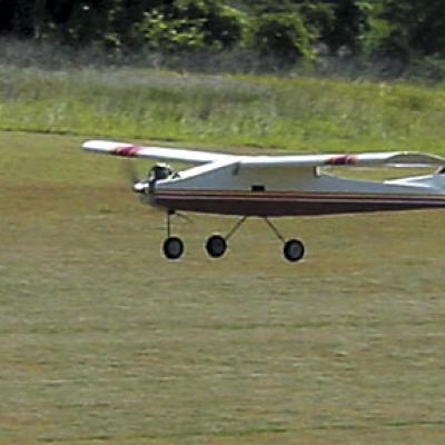a small plane flying over a field