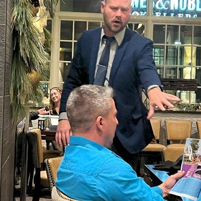 Two men holding model aircraft.