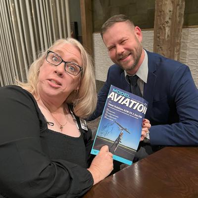 A woman looks at the Model Aviation magazine.
