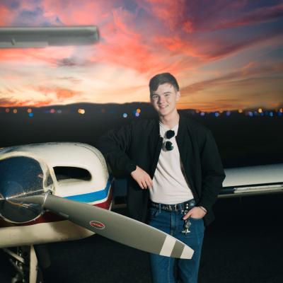 Tristan Hoel with aircraft posing for the camera