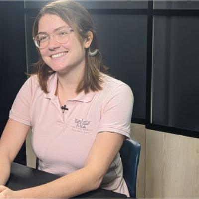 Gwen Mathis prepares for the livestream meeting with students at a K-8 STEM school with a smile on her face. 