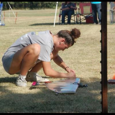 a young woman working on a model plane