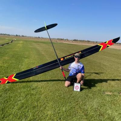 a young man holding a model plane