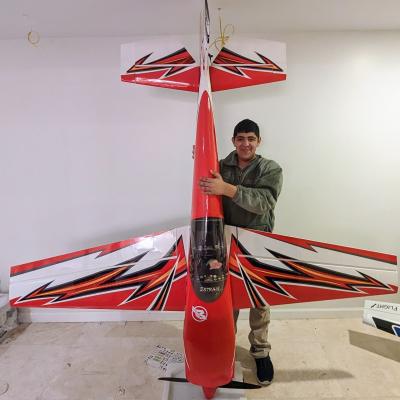 A young man holding a model plane