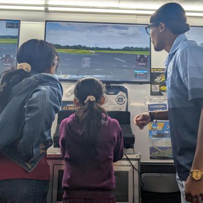 Ashton helping people fly on ama simulator. 