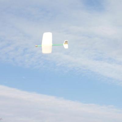 glider flying in a partly cloudy sky