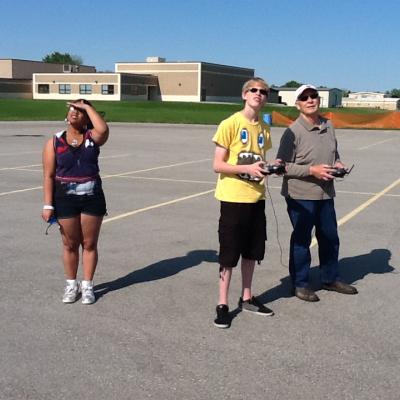 a group of people standing in a parking lot