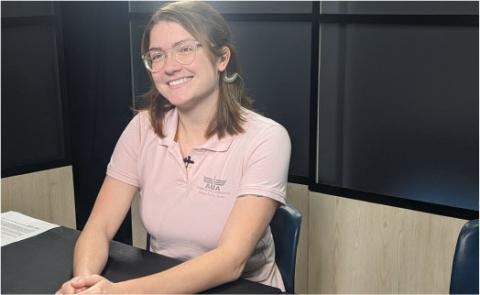 Gwen Mathis prepares for the livestream meeting with students at a K-8 STEM school with a smile on her face. 