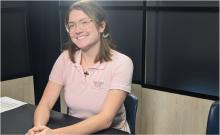 Gwen Mathis prepares for the livestream meeting with students at a K-8 STEM school with a smile on her face. 
