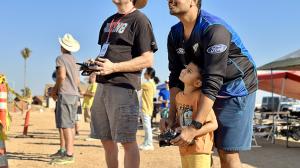 a group of people standing on top of a sandy beach