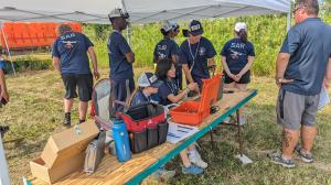 students working on drones with instructor