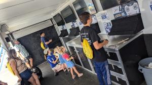 Young aviation enthusiasts practice flying in the AMA SIM Trailer 