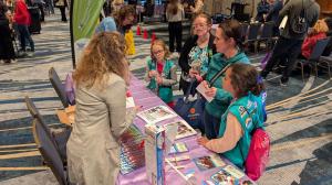 A group of women and girls talking about AMA educational resources.