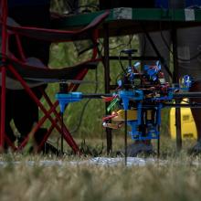 drone sitting in the grass, ready to fly soon
