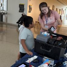 AMA employee showing quadcopter to students
